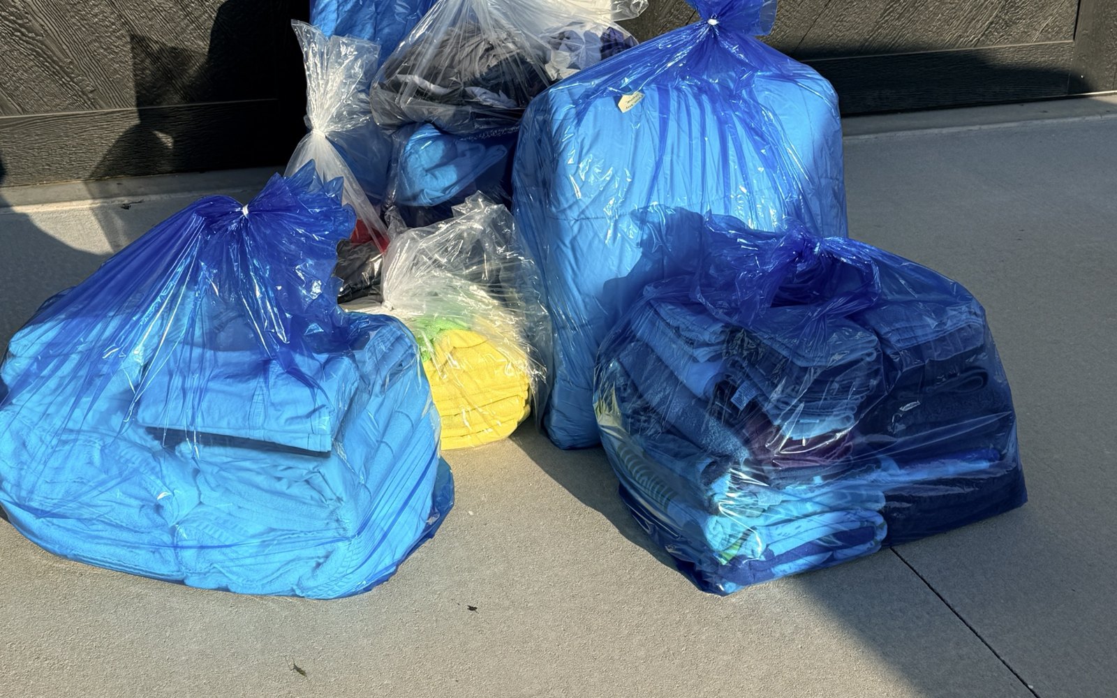 Clean, bagged laundry being delivered by Top Tier Coin Laundry